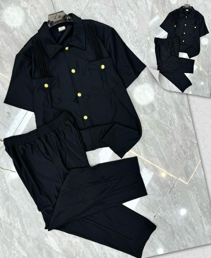 Black pleated button-up shirt and pants two-piece set with gold buttons.