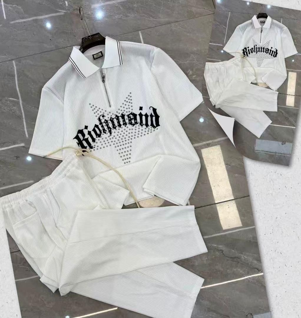 White ribbed zip polo and pants two-piece set with Richmond graphic on tiled floor.