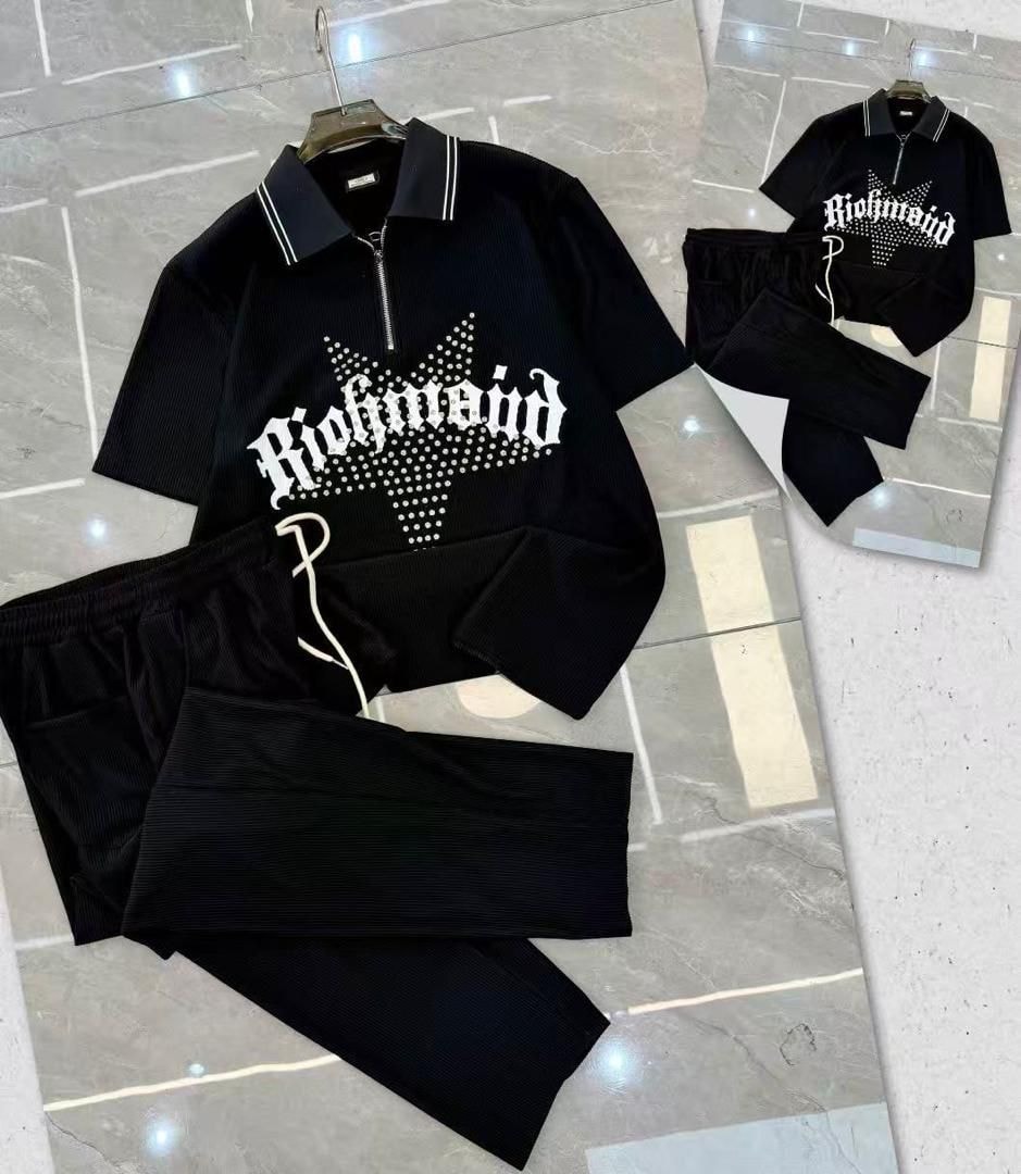 Black ribbed zip polo and pants two-piece set with Richmond graphic on tiled floor.