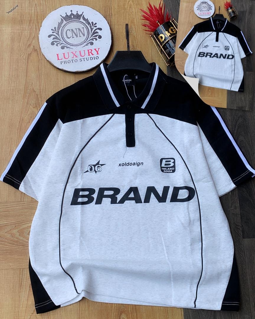 White and black colorblock polo shirt with large BRAND print.