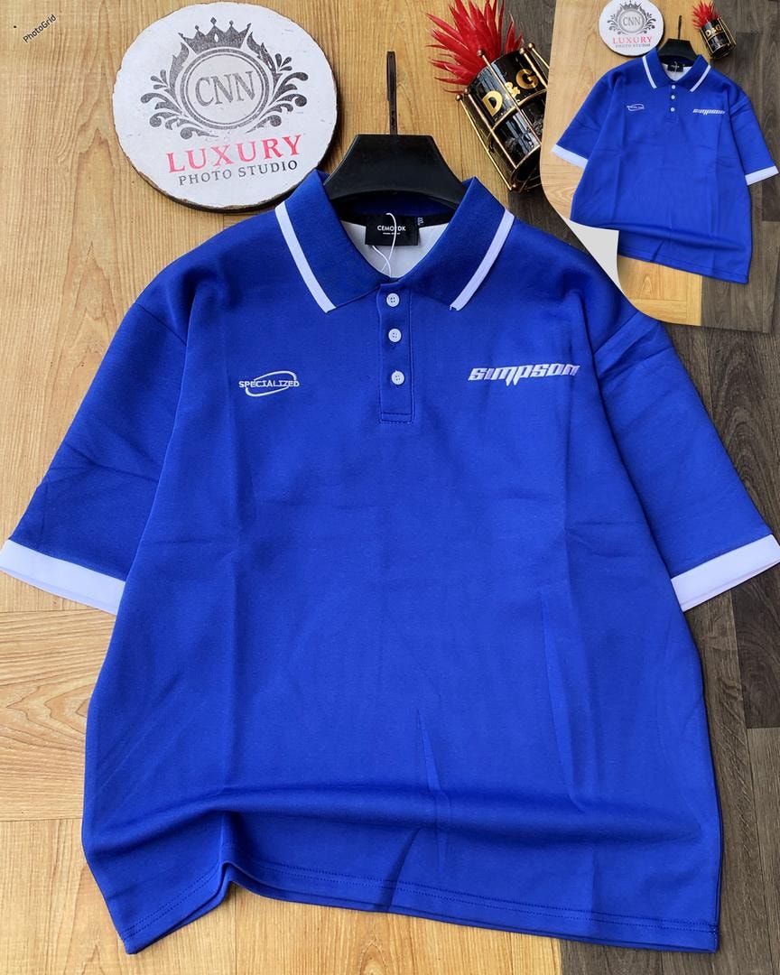 Blue polo shirt with white contrast trim and chest embroidery.