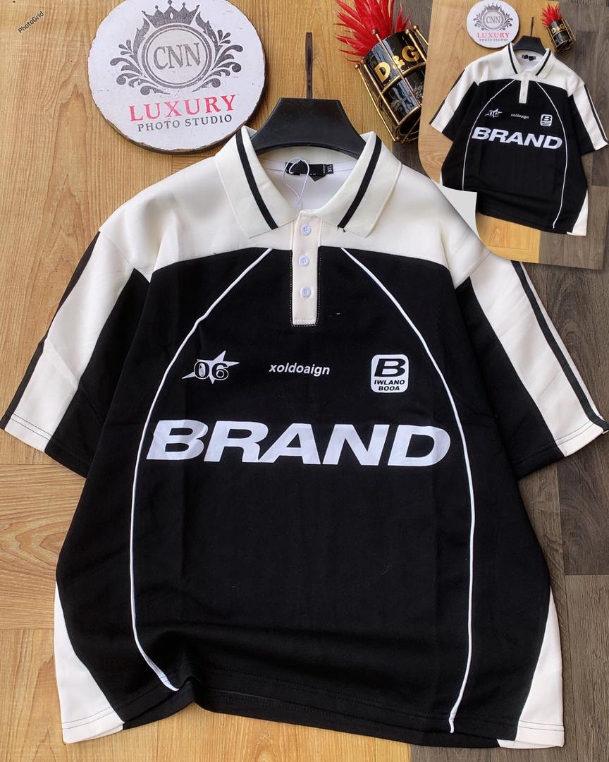 Black and white colorblock polo shirt with large BRAND print.