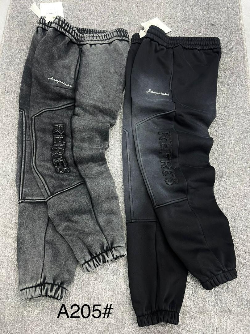 Black and gray RETRES embroidered joggers displayed side by side.
