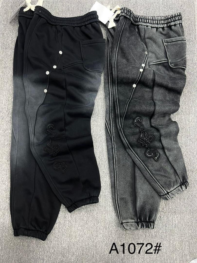 Black and gray logo embroidered joggers with side snaps shown side by side.