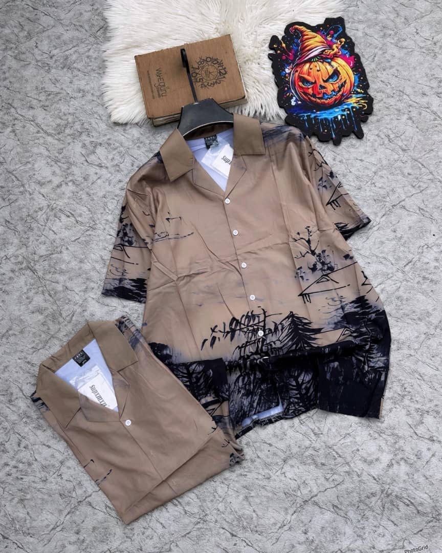 Brown short sleeve shirt with black abstract print and matching shorts laid flat.