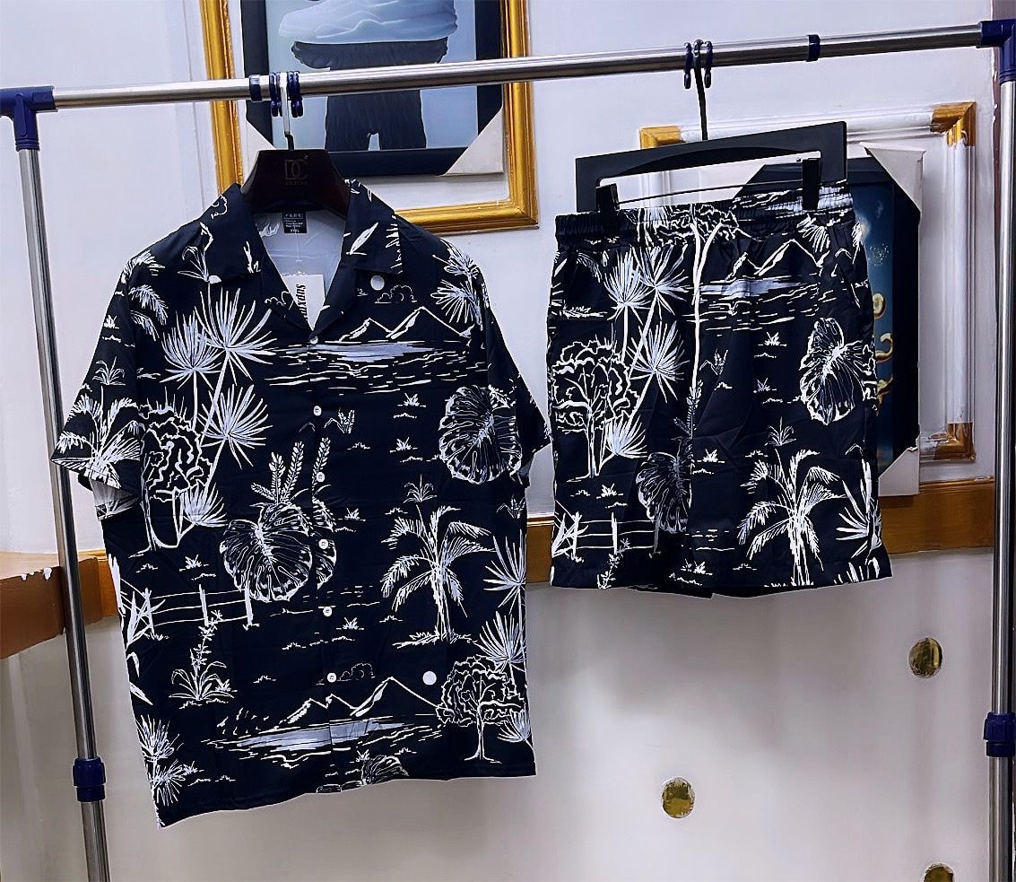 Black shirt and shorts set with white palm tree and landscape print.