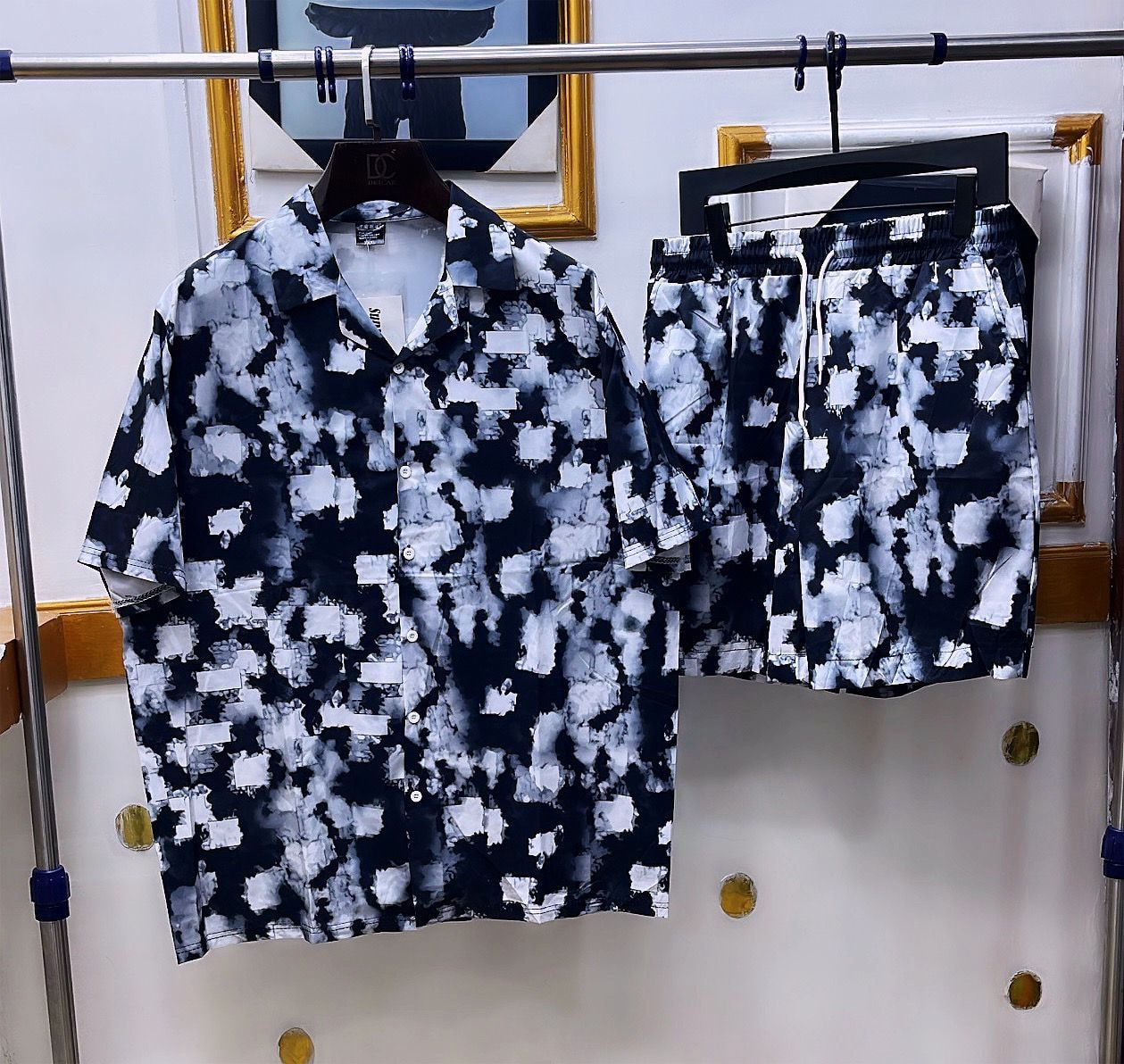 Black and white shirt and shorts set with abstract square pattern.