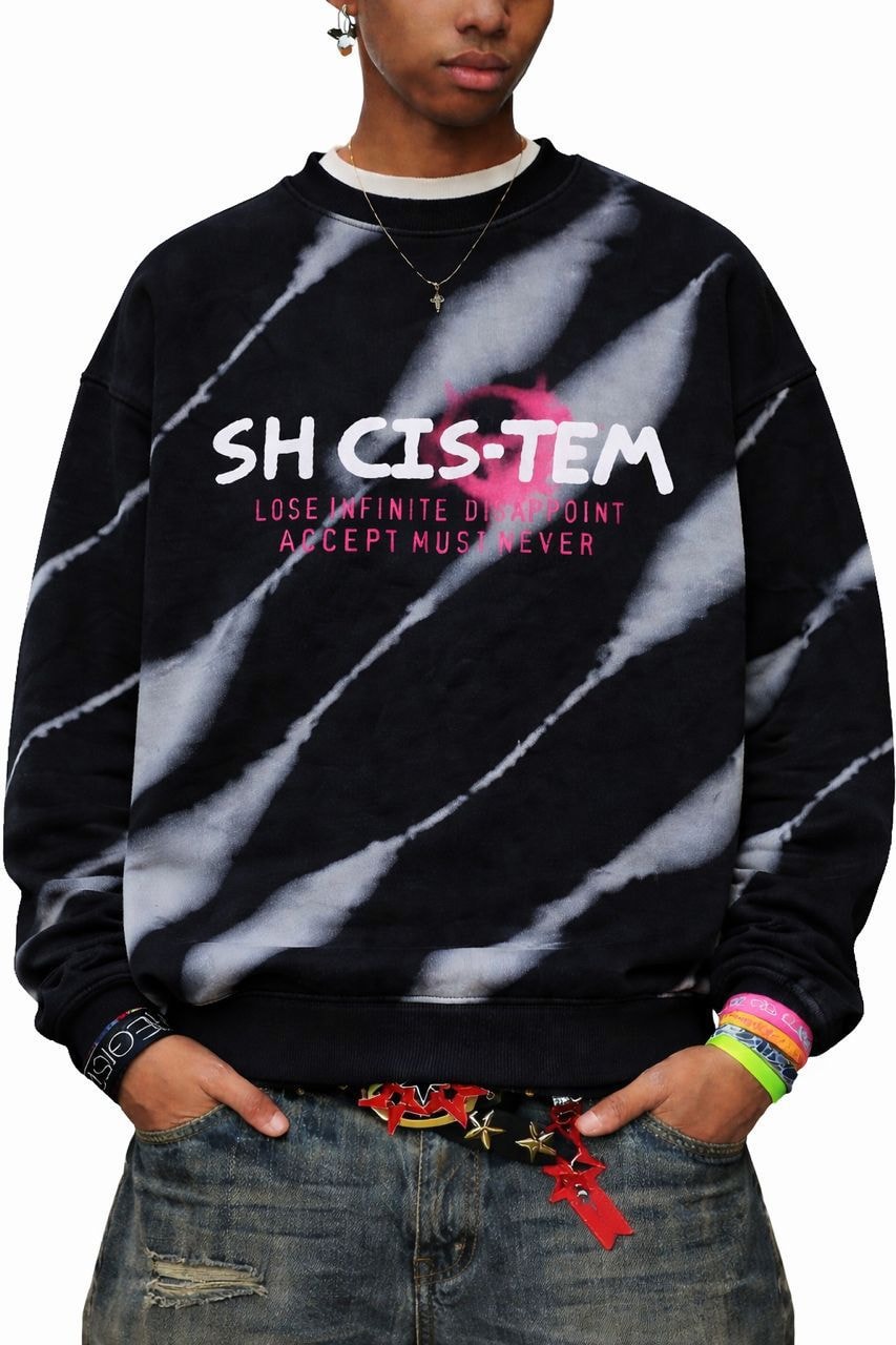 Model wearing black tie-dye SH CIS-TEM sweatshirt with graphic text.