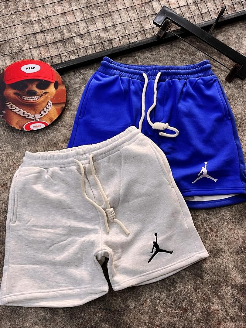 Blue and light grey fleece jogger shorts displaying Jumpman design.