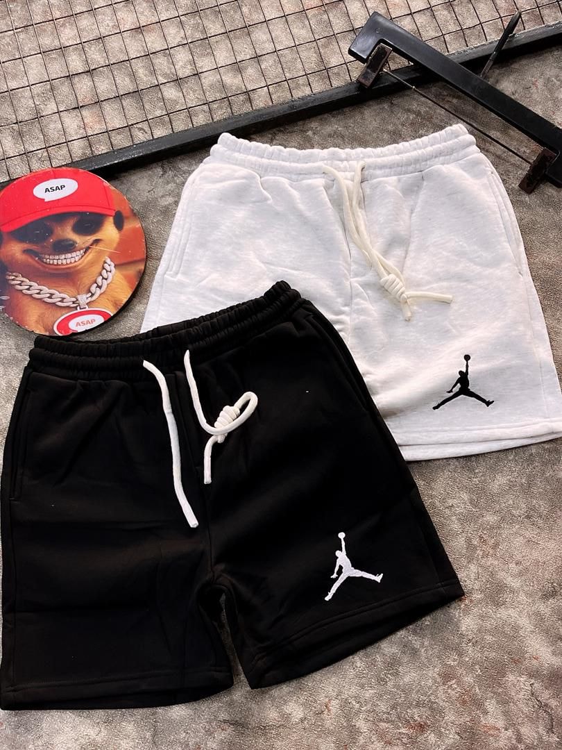 Black and white fleece jogger shorts with Jumpman embroidery and drawstring waist.