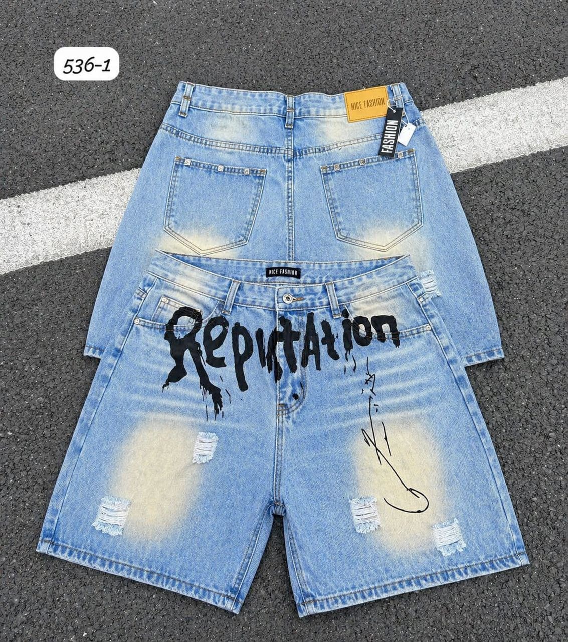 Back views of light blue denim shorts including one with Reputation graphic print and distressing.