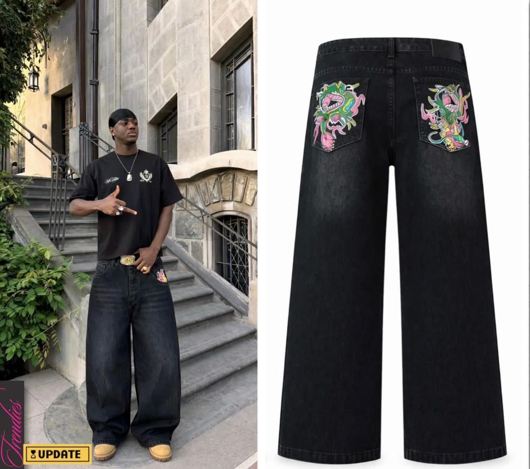 Black baggy jeans with colorful dragon and monster graphics on back pockets.