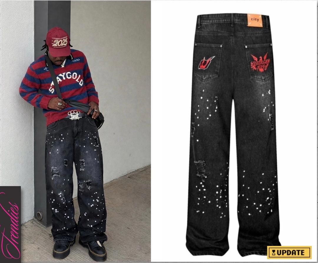 Black baggy jeans with white splatter pattern, rips, and red graphic prints on back pockets.