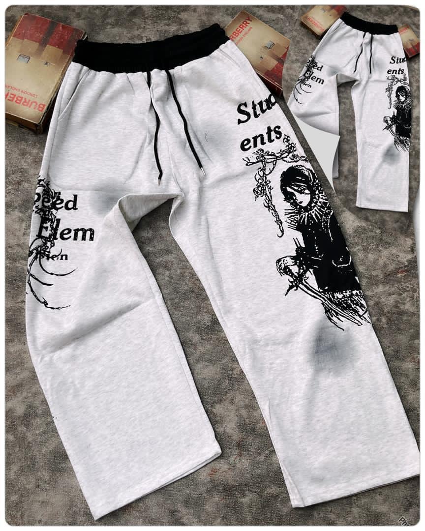 White joggers with black gothic graphic prints and text on the legs.