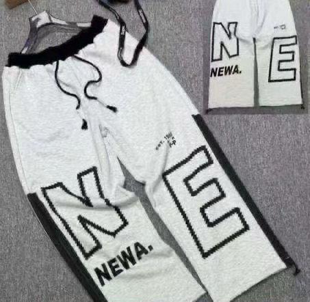 Gray joggers with large NEWA letter prints and black side accents.