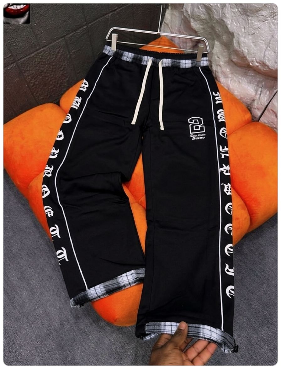 Black joggers with white side prints, logo on thigh, and plaid cuffs.