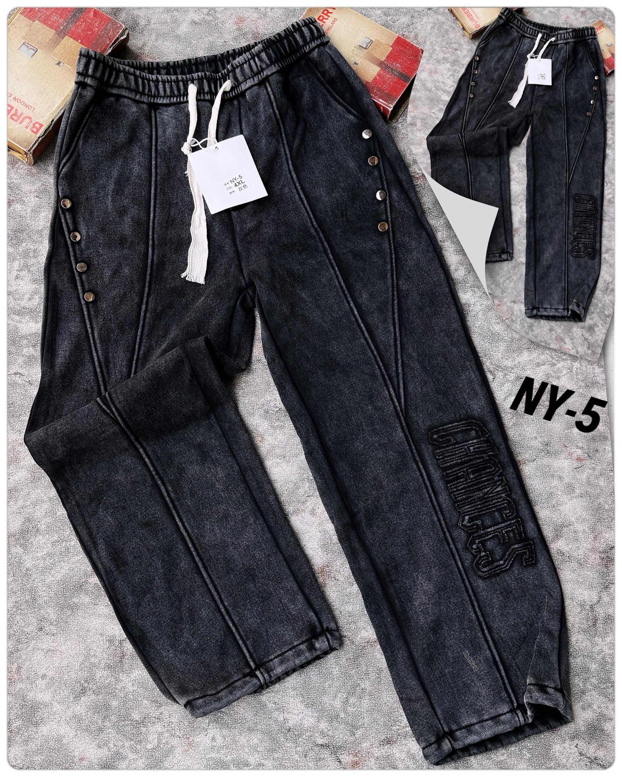 Black joggers with side snap buttons, white drawstring, and 'CHANCES' embroidery on the leg shown flat with tag.