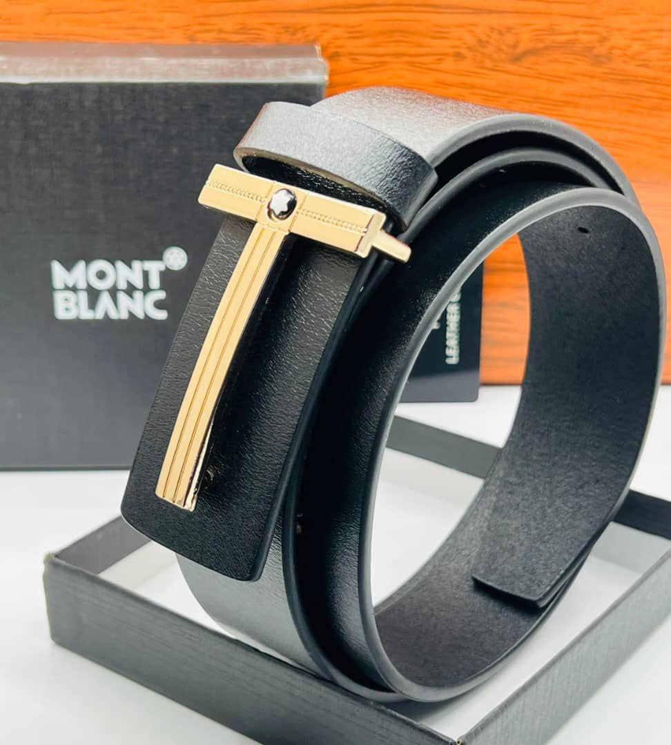 Black leather Montblanc belt with gold T-shaped buckle shown with branded black box on wooden surface.
