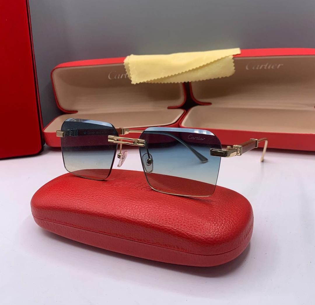 Cartier rimless sunglasses with blue gradient lenses and gold hardware.