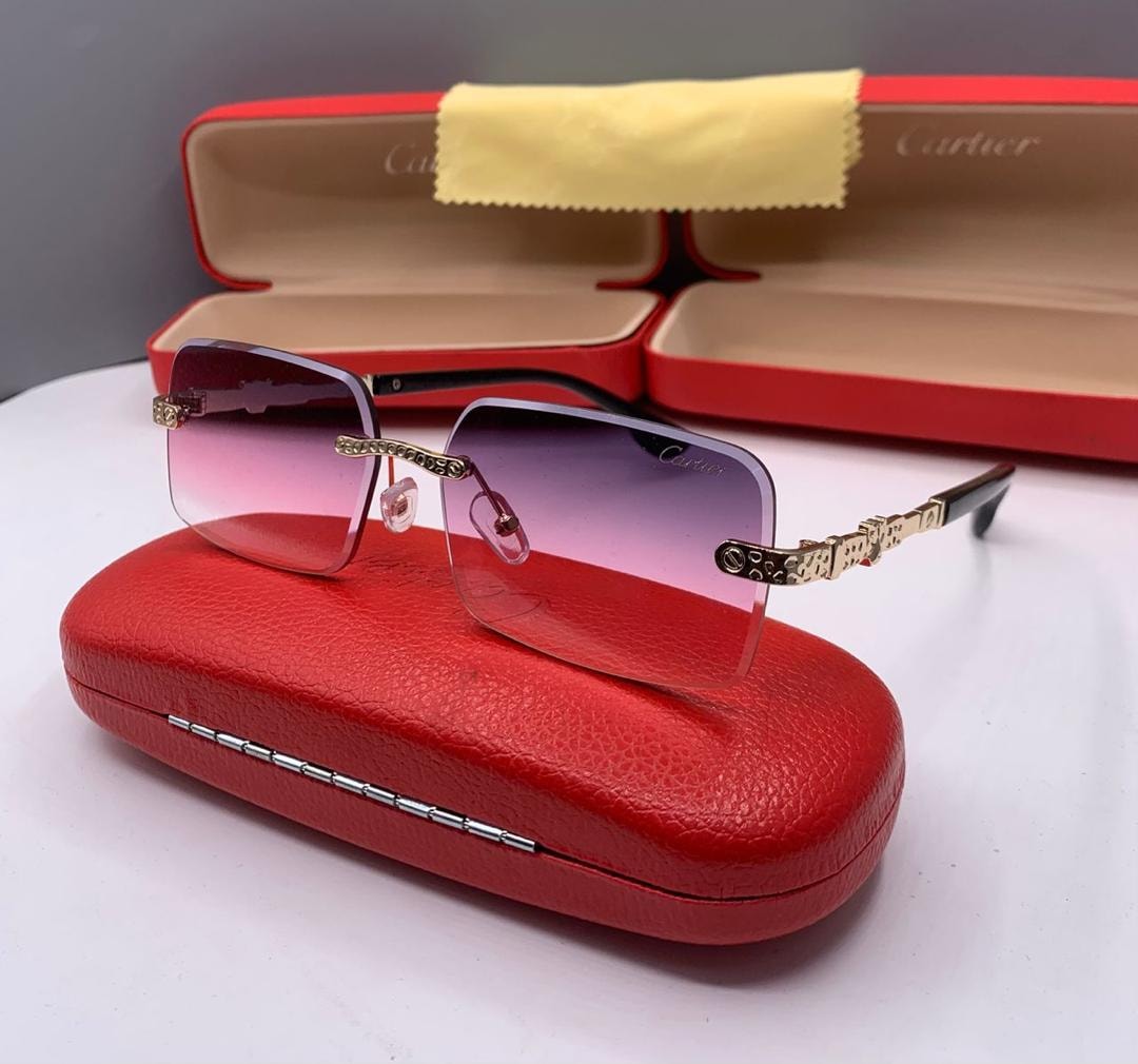 Cartier rimless sunglasses with purple gradient lenses on red case.