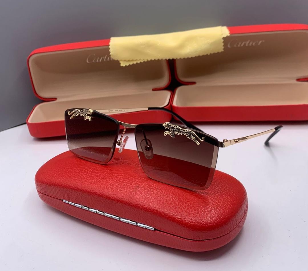 Cartier square sunglasses with brown gradient lenses and gold panther motifs on frame.