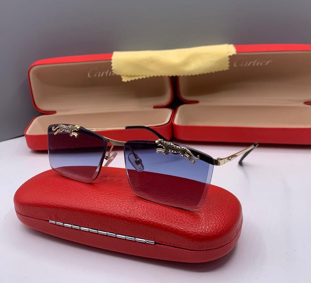 Cartier square sunglasses with blue gradient lenses and gold panther motifs on frame.