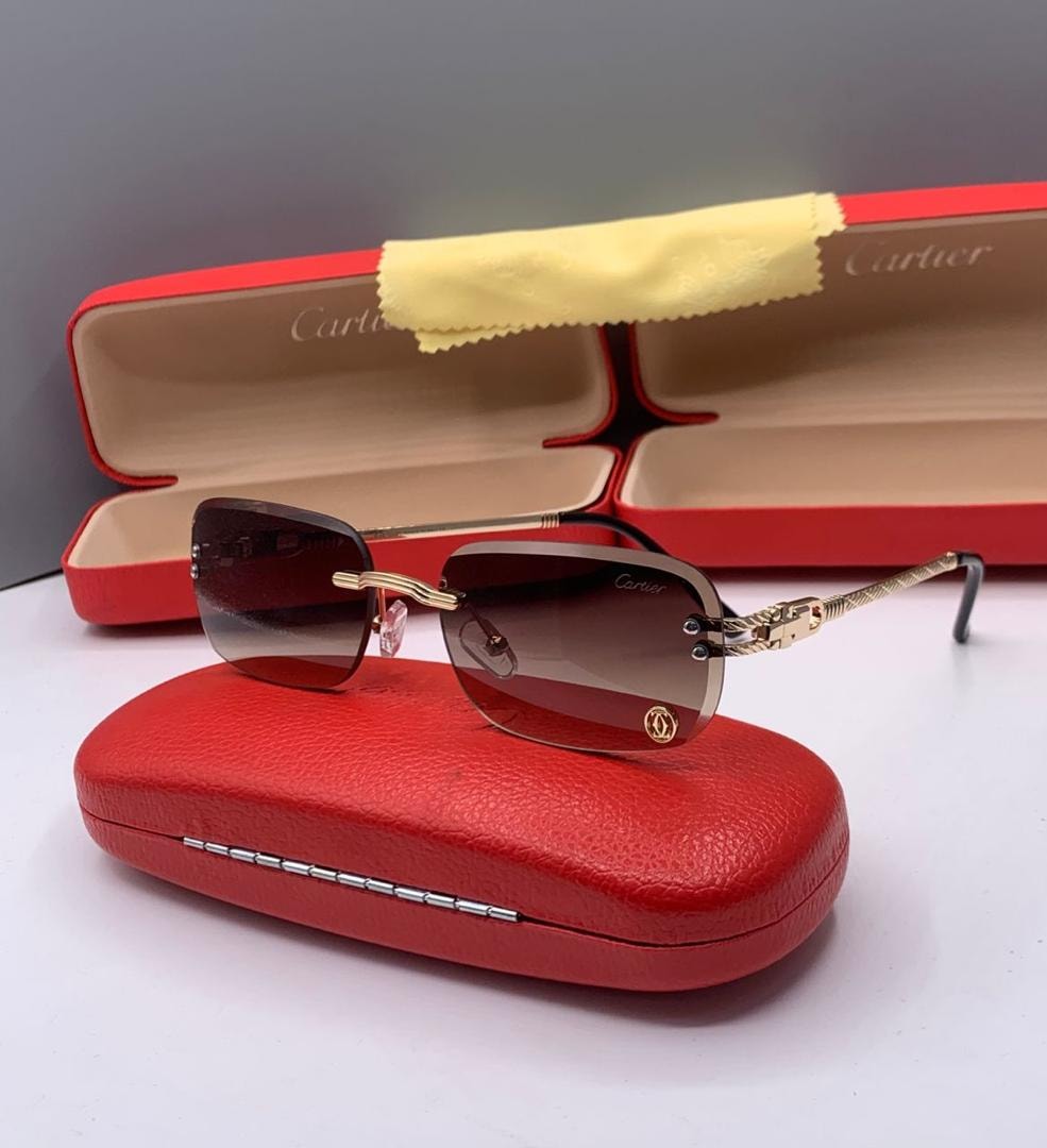 Cartier rimless glasses with brown gradient lenses on red case.