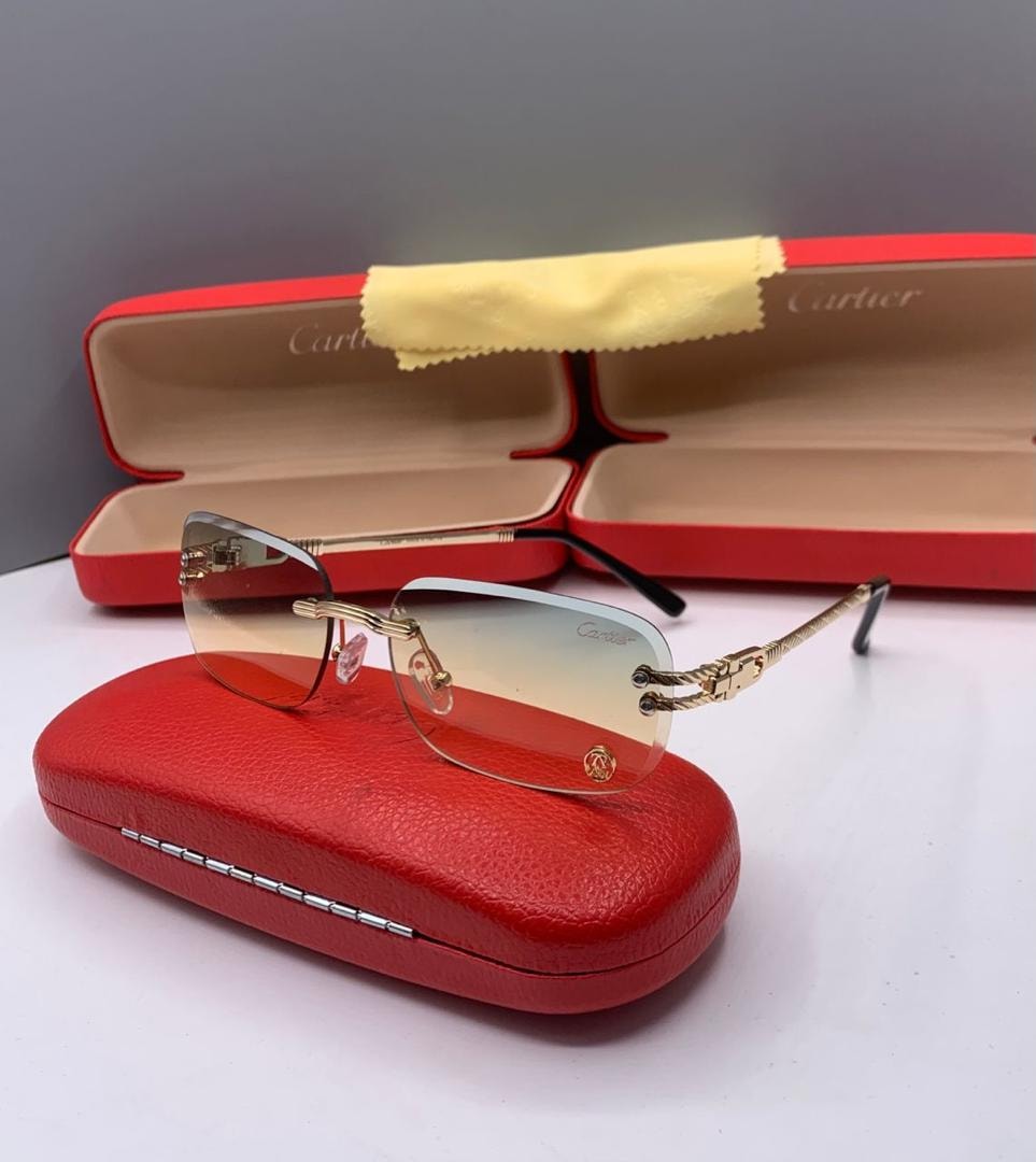 Cartier rimless glasses with light blue to yellow gradient lenses.