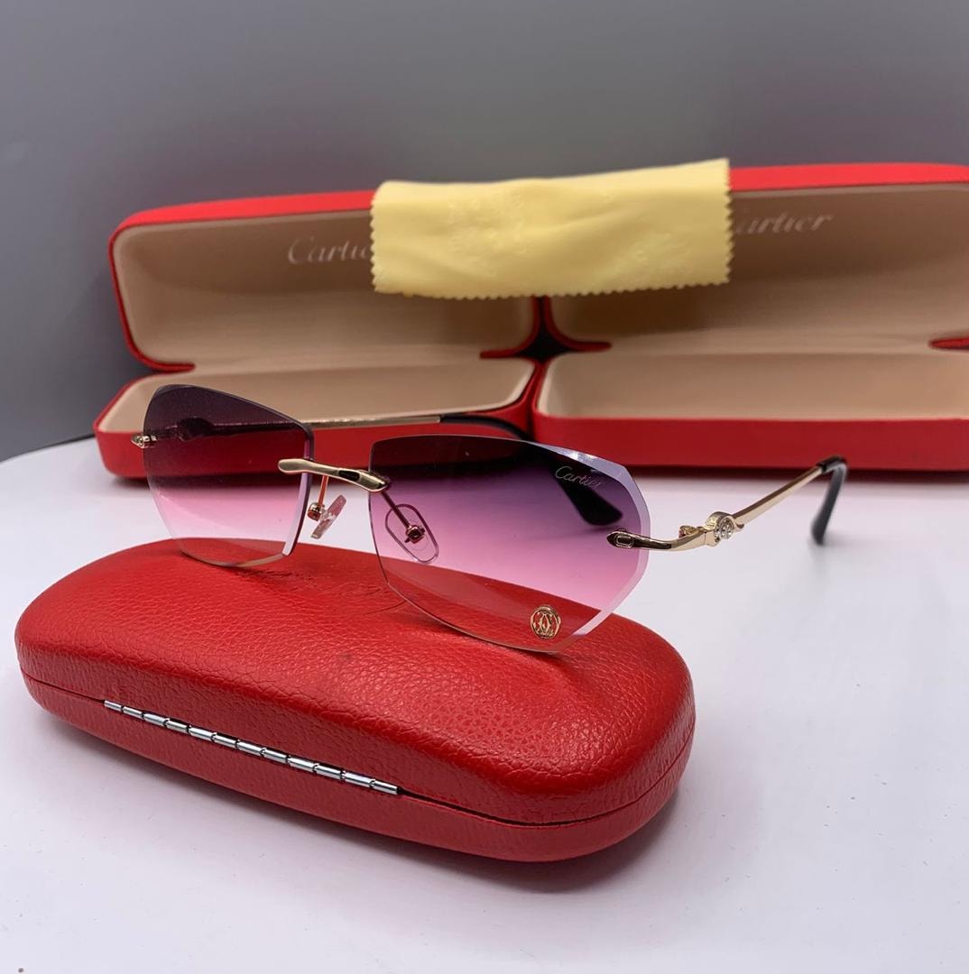 Cartier rimless glasses with pink gradient lenses and gold details.
