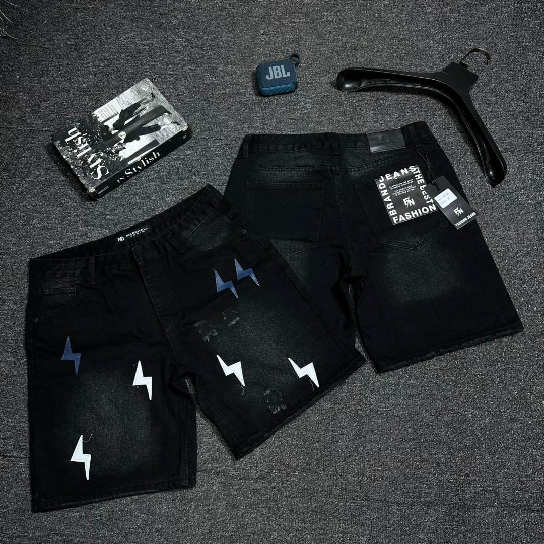 Black denim shorts with white and blue lightning bolt prints and distressed details, front and back views.