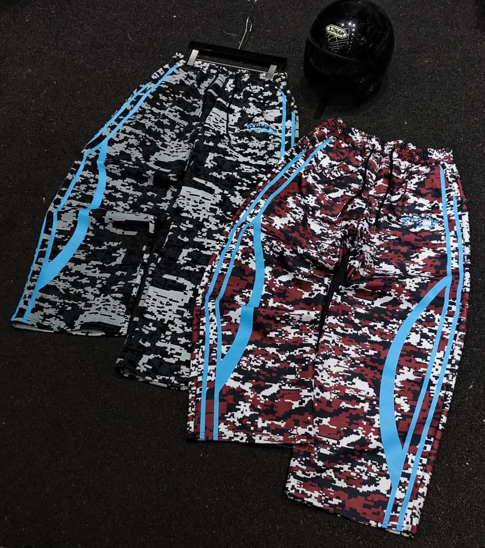 Black and red digital camouflage joggers with blue side stripes shown side by side.