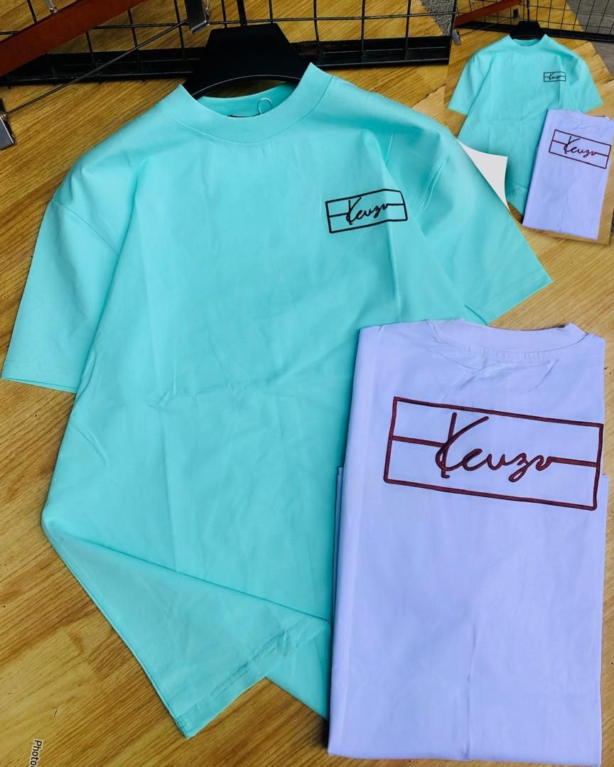 Mint green and purple Keuzo logo t-shirts on wooden floor with detail insets.