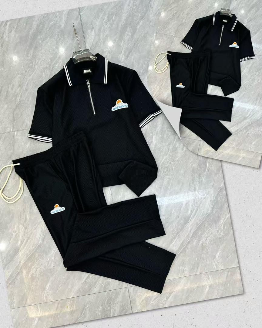 Black Casablanca two-piece set with striped collar polo and pants.
