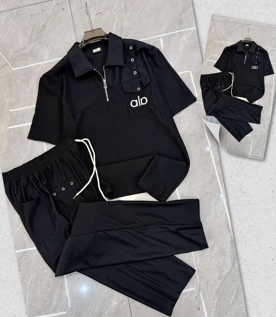 Black Alo two-piece set showing chest pocket and drawstring pants.