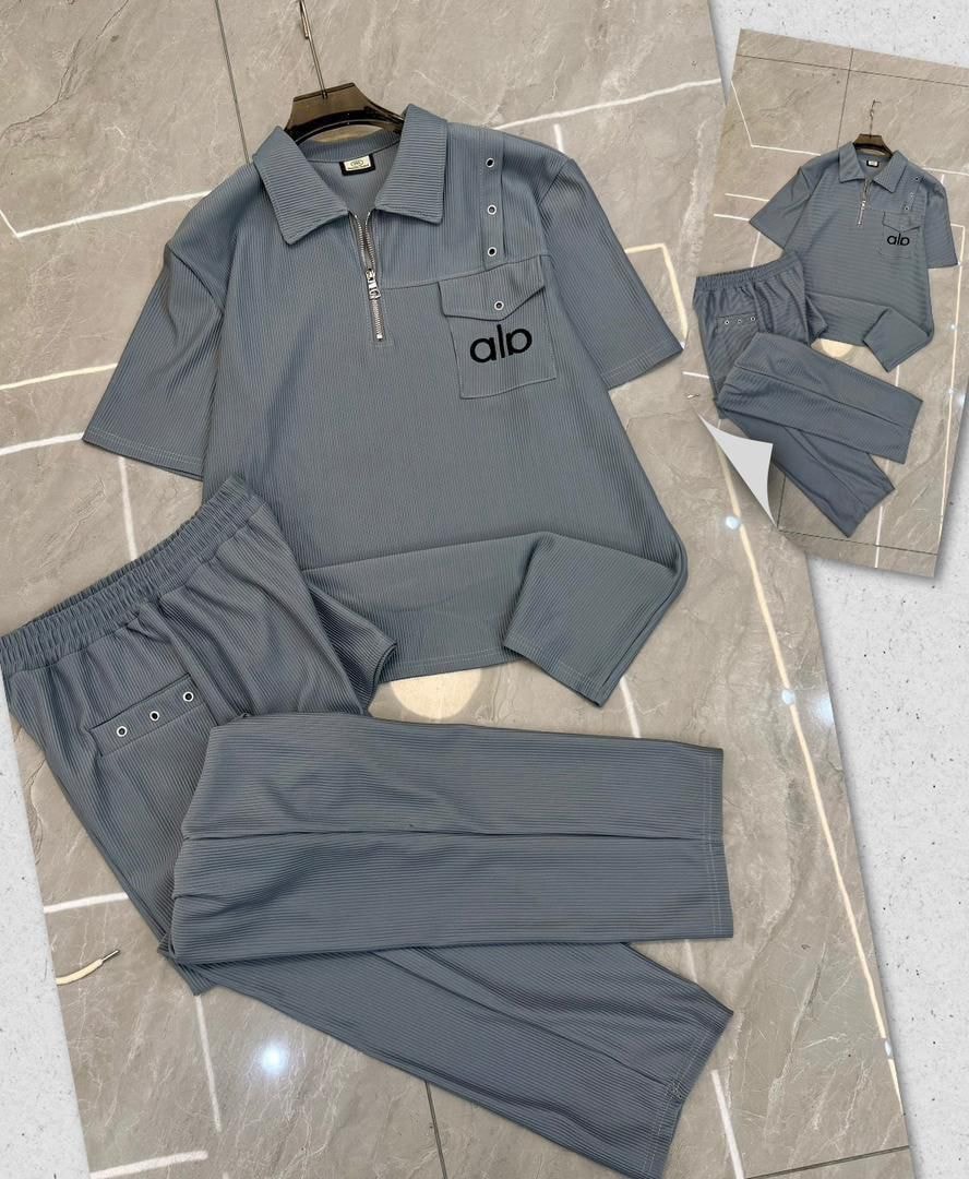 Gray Alo ribbed polo set with matching trousers.