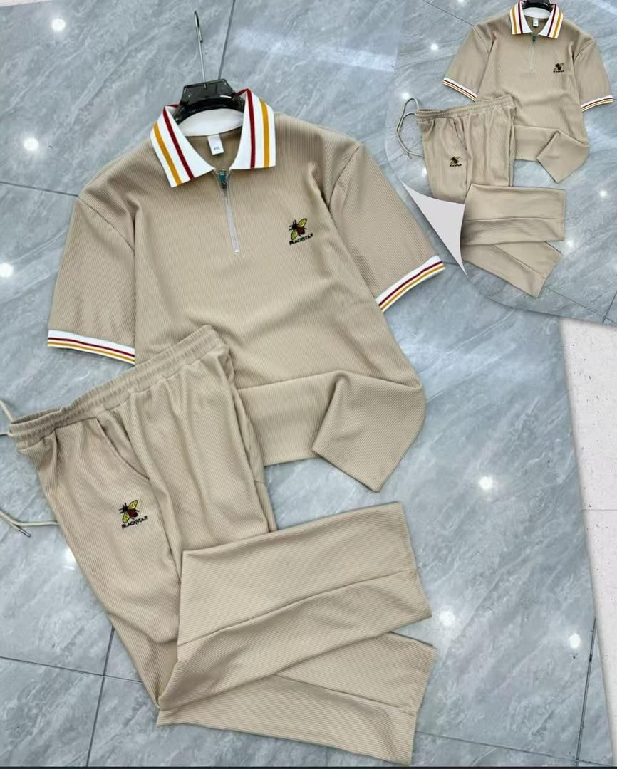 Beige Blackstar two-piece set with quarter-zip polo and trousers.