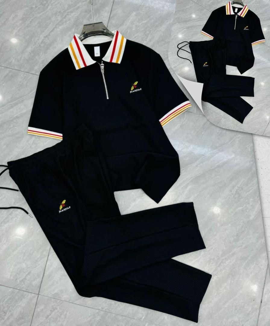 Black Blackstar ribbed two-piece set laid flat showing embroidered details.
