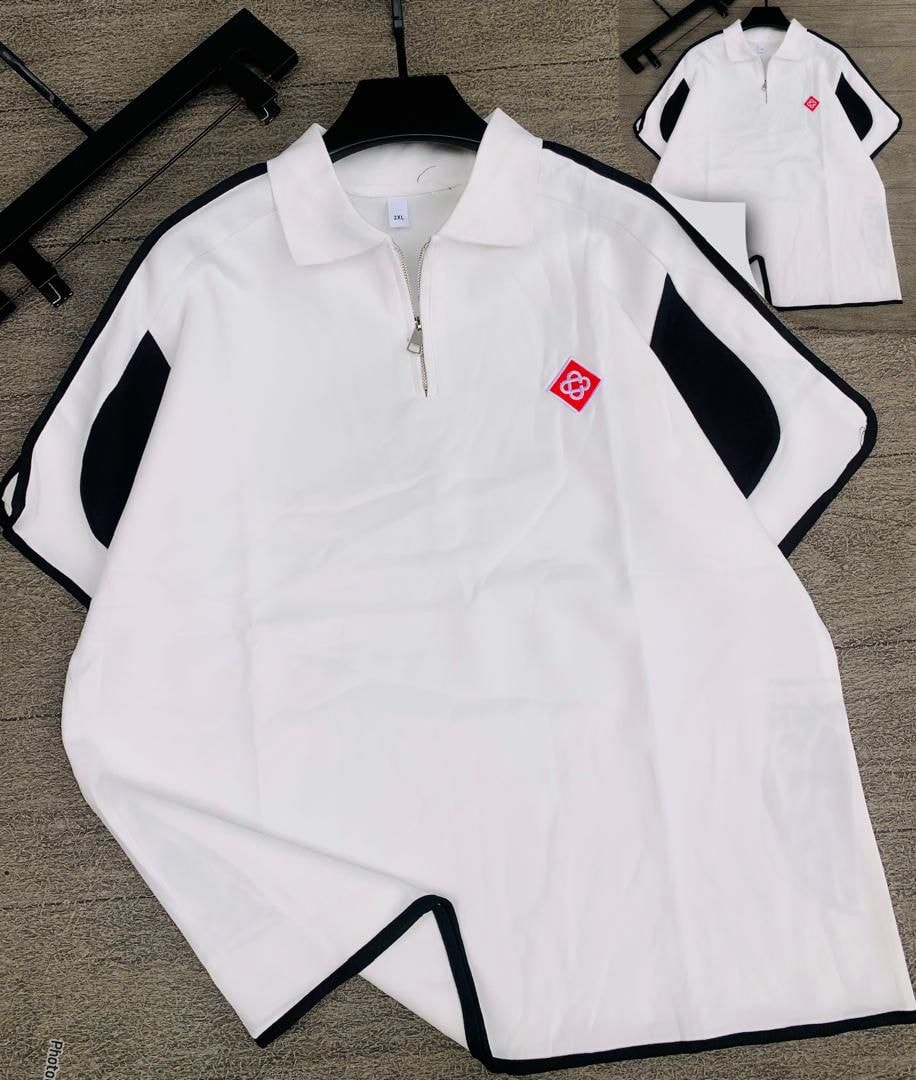 White long sleeve zip collar polo with black contrast panels and red chest logo.