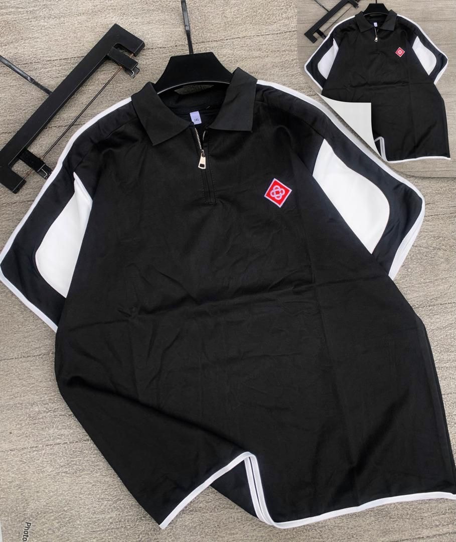 Black long sleeve zip collar polo with white contrast panels and red chest logo.