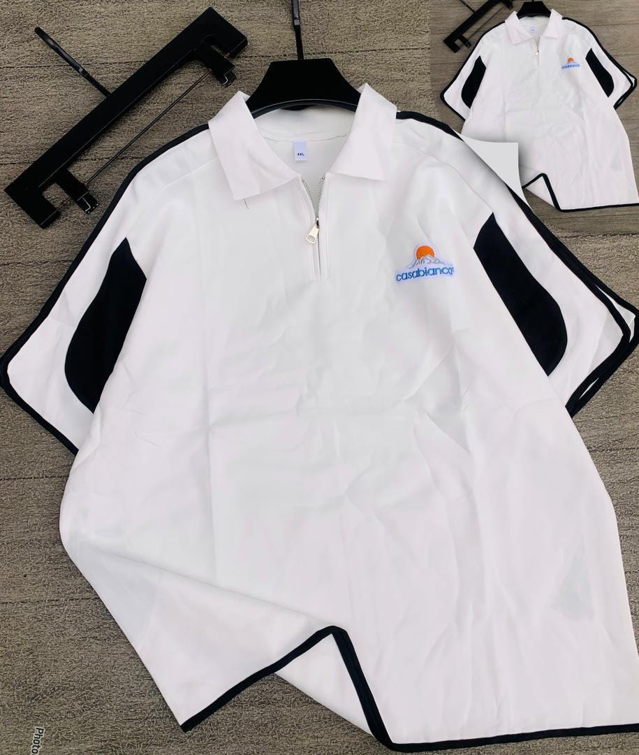 White short sleeve zip polo shirt and matching shorts with black contrast panels.