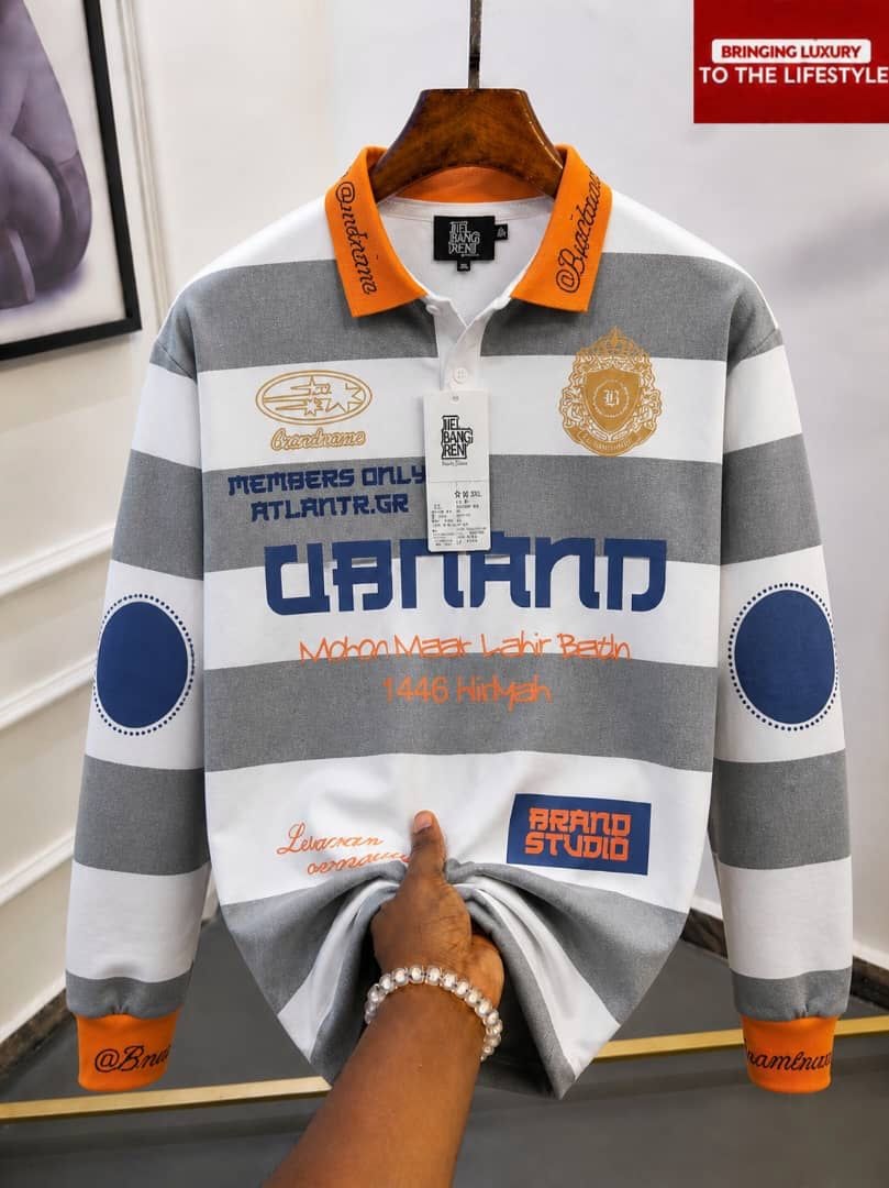 Gray and white striped long sleeve polo with orange collar and multiple graphic prints.