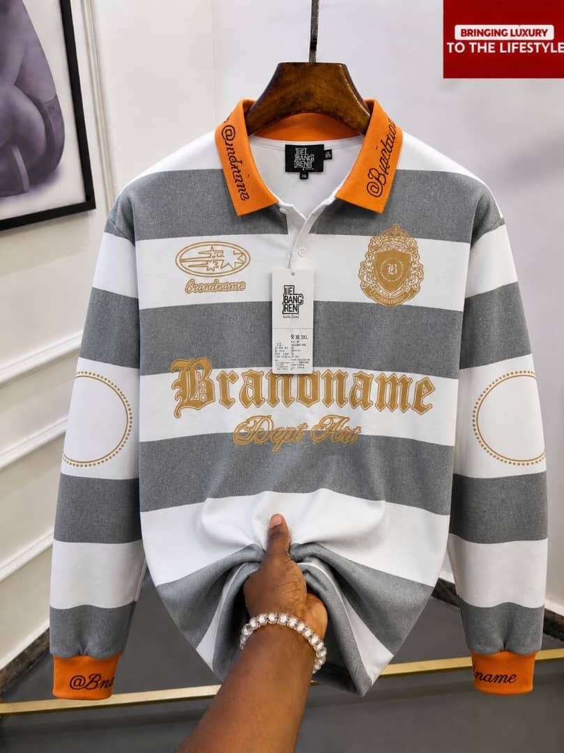 Gray and white striped long sleeve polo with orange collar and Brandname embroidery.