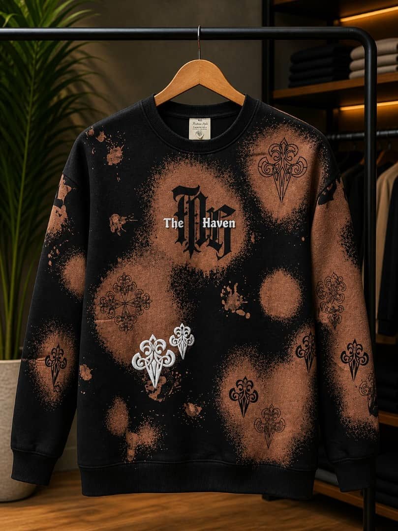 Black sweatshirt with brown splatter and white gothic ornate prints.