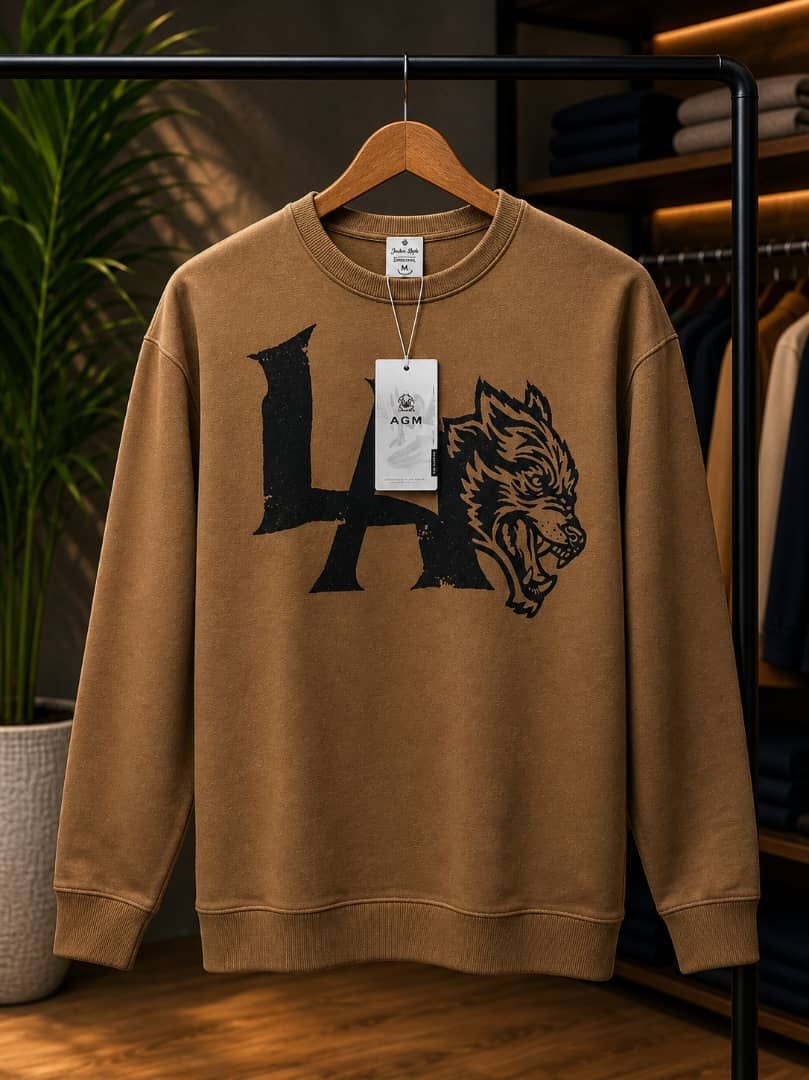 Brown LA Wolf graphic sweatshirt on wooden hanger.