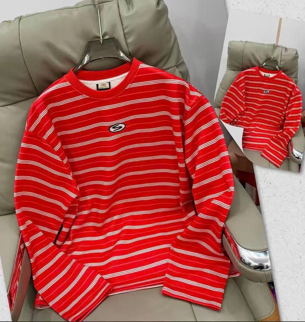 Red striped long sleeve top with white horizontal lines and chest logo on hanger.