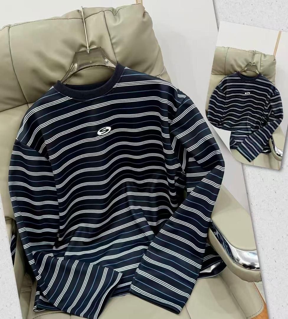 Navy striped long sleeve top with white horizontal lines and chest logo on hanger.