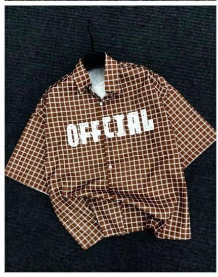 Brown checkered short sleeve shirt with OFFICIAL print on chest.