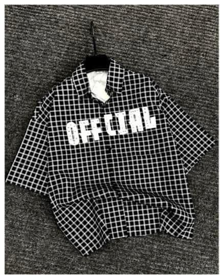 Black checkered short sleeve shirt with OFFICIAL print on chest.
