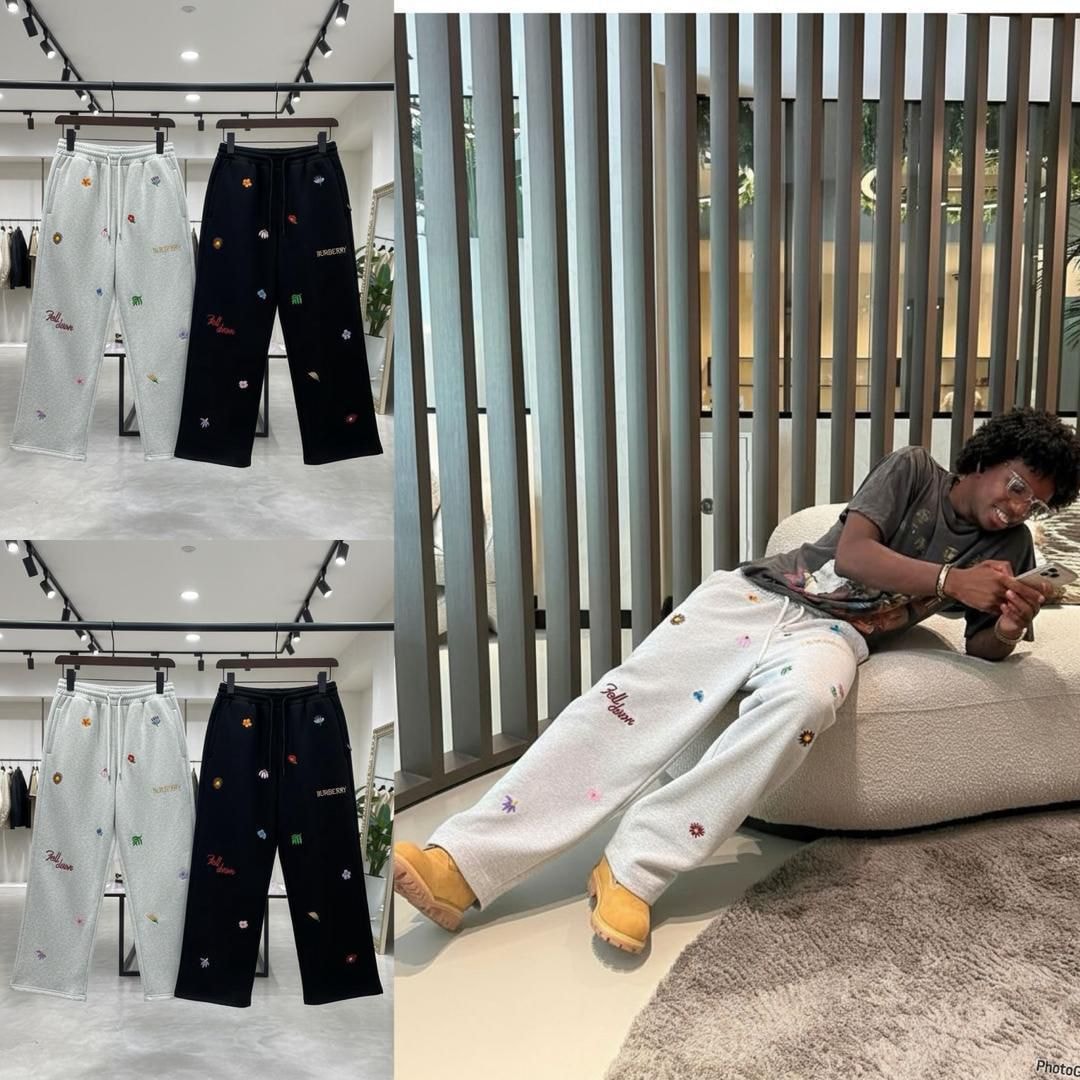 Light gray and black floral embroidered joggers on hangers plus lifestyle shot of model wearing the gray pair.