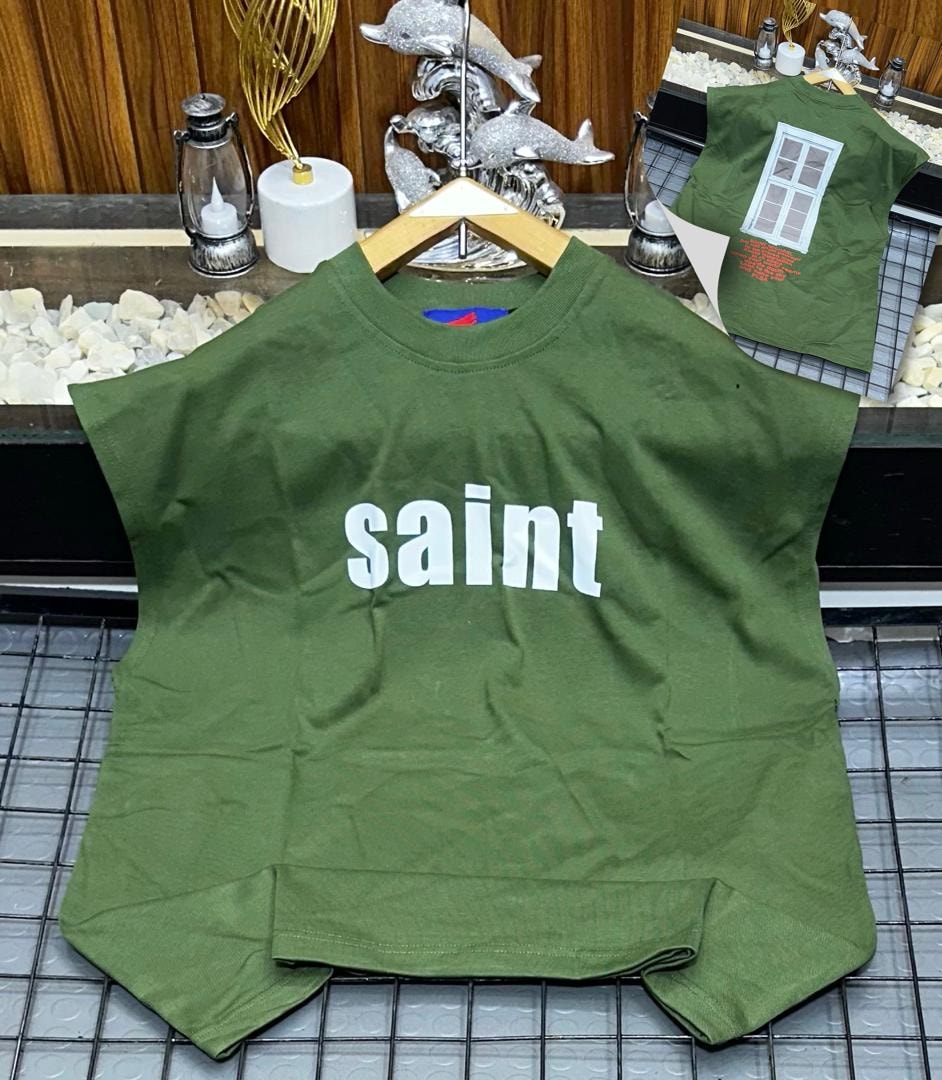 Green oversized armless top with white saint text print on chest.